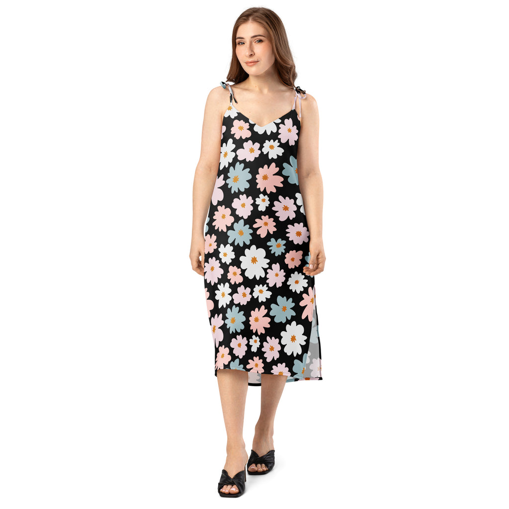 Women’s retro floral slip dress in black with delicate spaghetti straps and vibrant pink white and blue daisy pattern midi dress