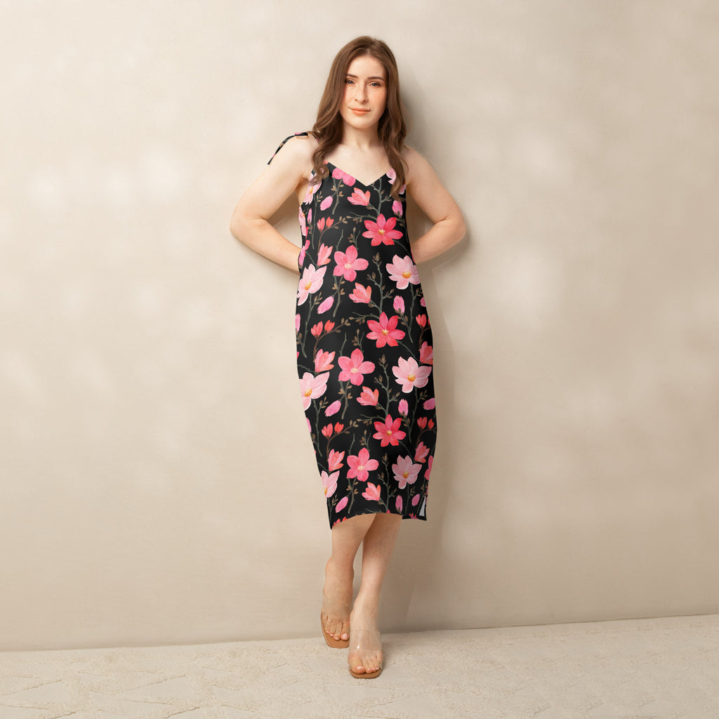 Women’s black floral midi slip dress with pink blossoms featuring thin adjustable tie straps and built in bra