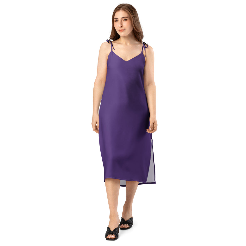Woman wearing a floral slip dress on a white background