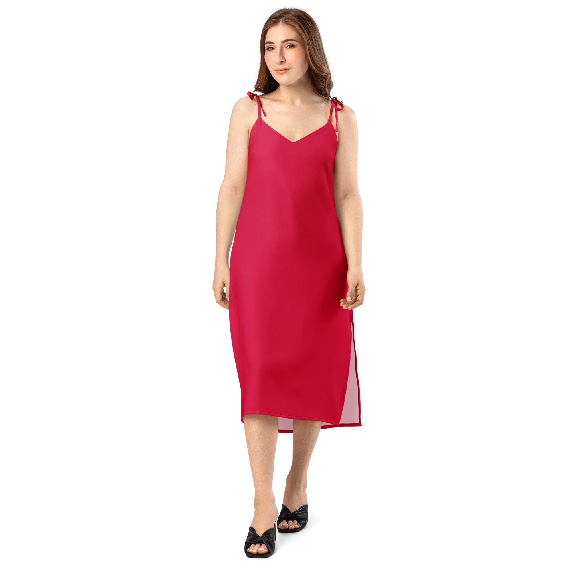 Woman wearing a red slip dress on a white background
