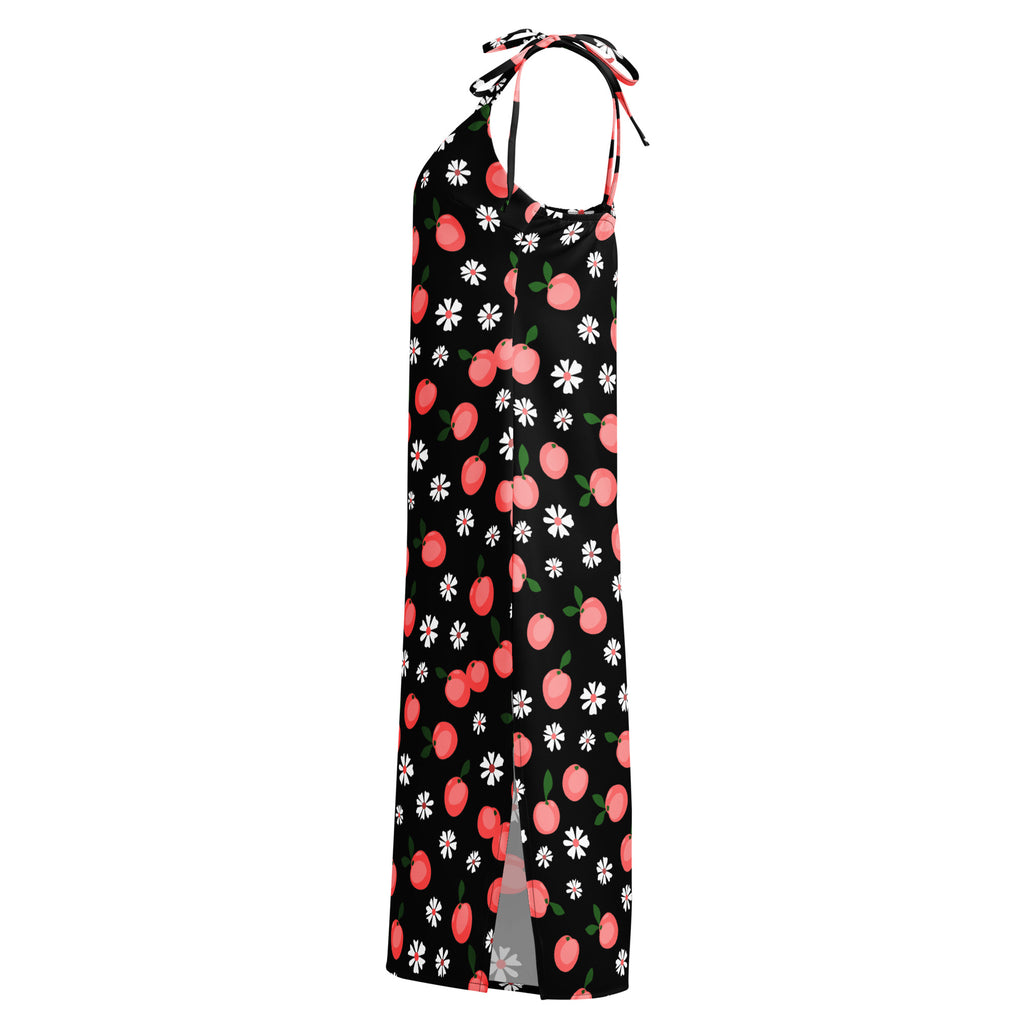 Black halter neck maxi dress with pink peach and white daisy print featuring adjustable tie straps and built in bra