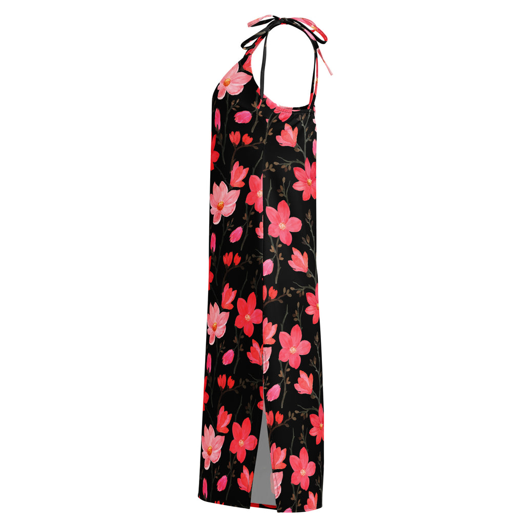 A black halter-neck maxi dress with vibrant pink and coral floral pattern and delicate tie straps at the neckline
