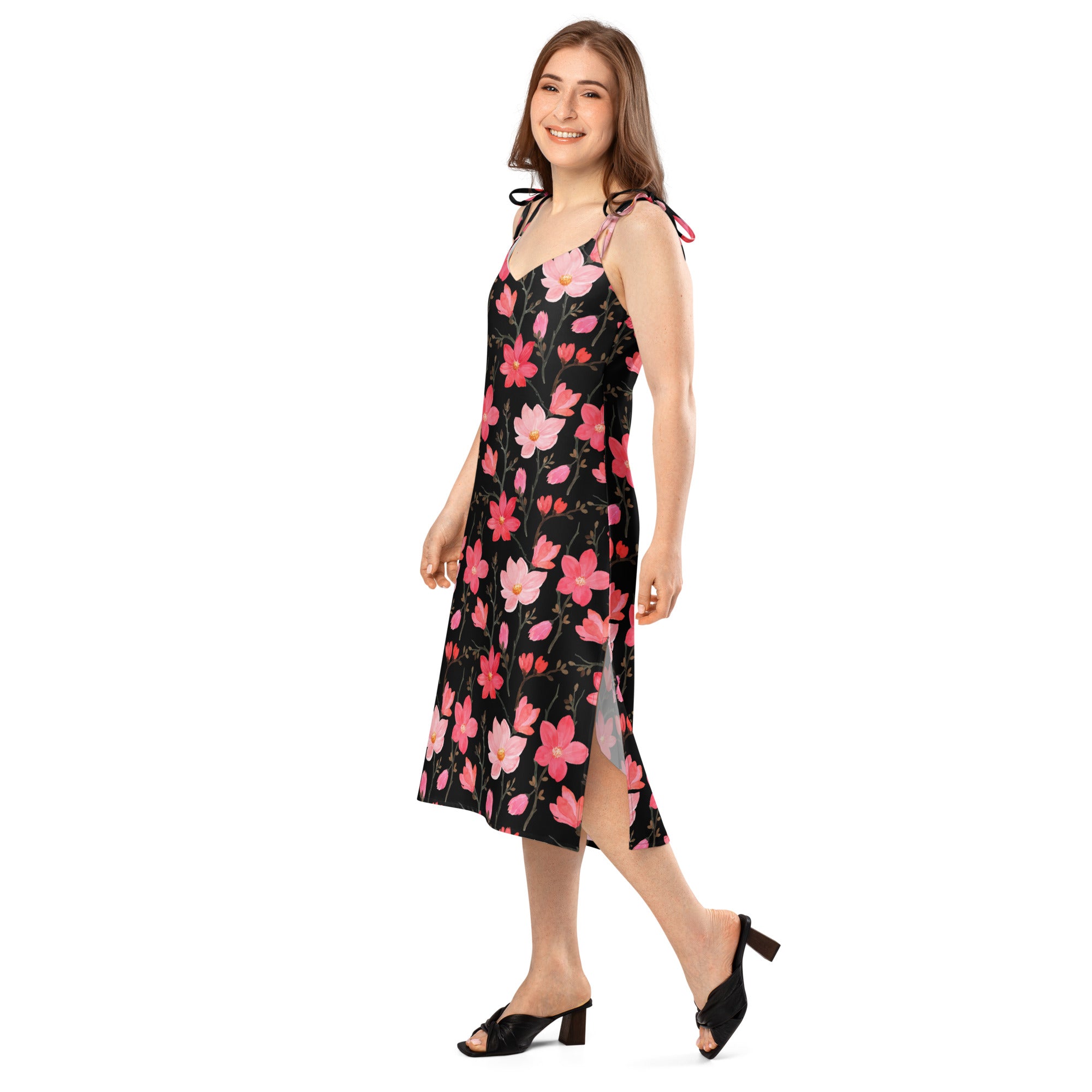 Women’s black floral print midi slip dress with pink and red blossoms, adjustable tie straps, side slit, and flowing silhouette