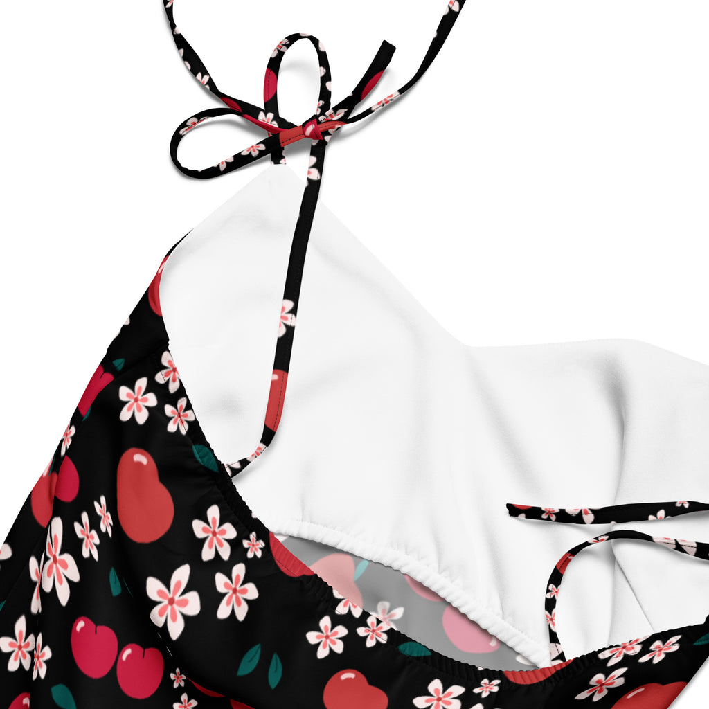 Women’s black and white cherry-themed halter top with floral pattern and adjustable tie straps for a stylish look