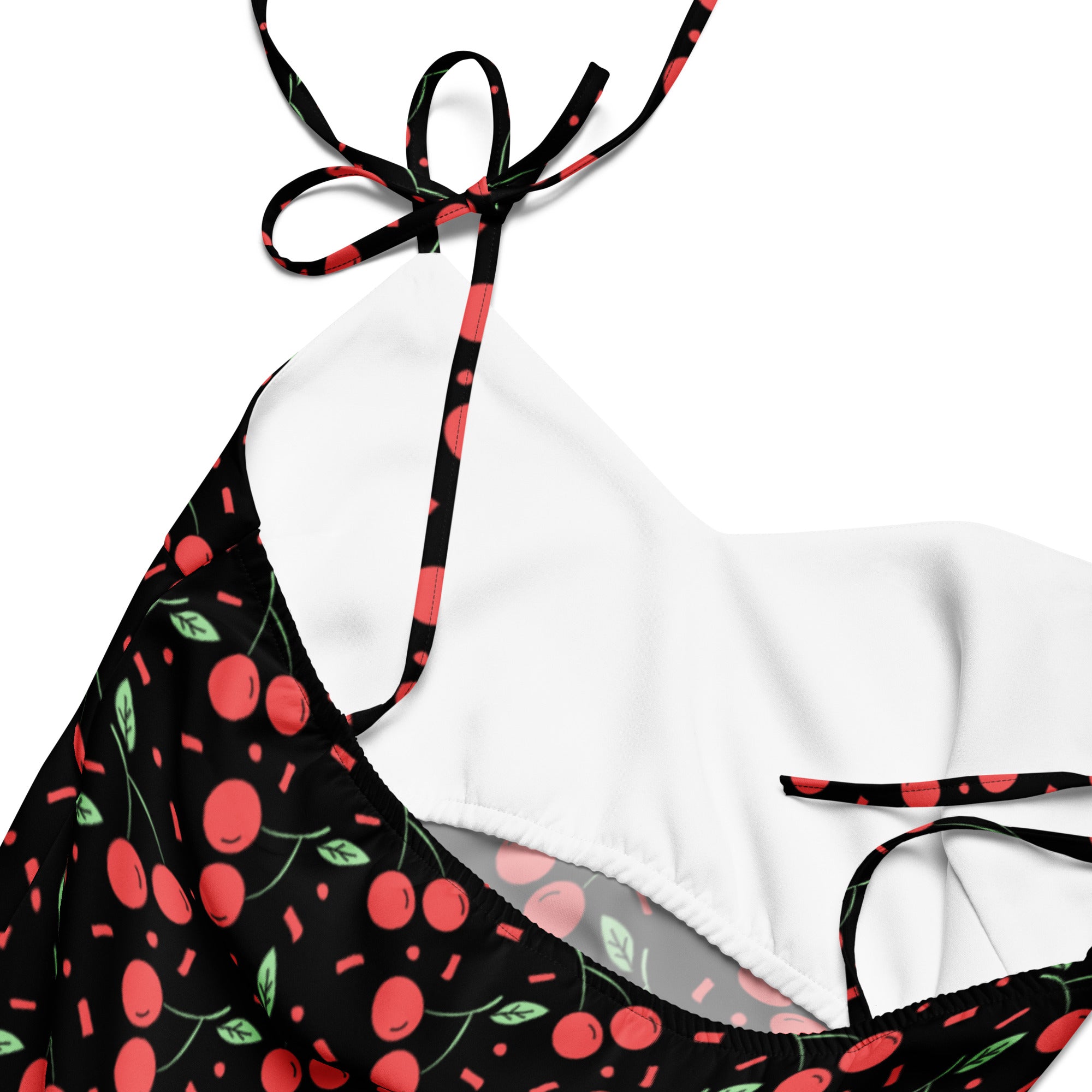Women’s black mini cherry slip dress with adjustable tie straps featuring a black and red cherry patterned halter top