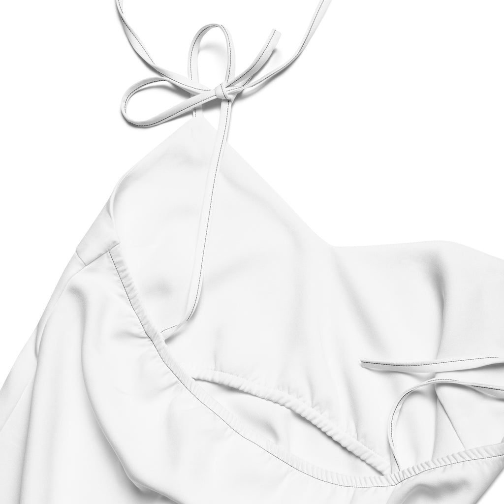 White halter-neck bikini top with delicate tie-back straps made of smooth stretchy fabric shown from the back side