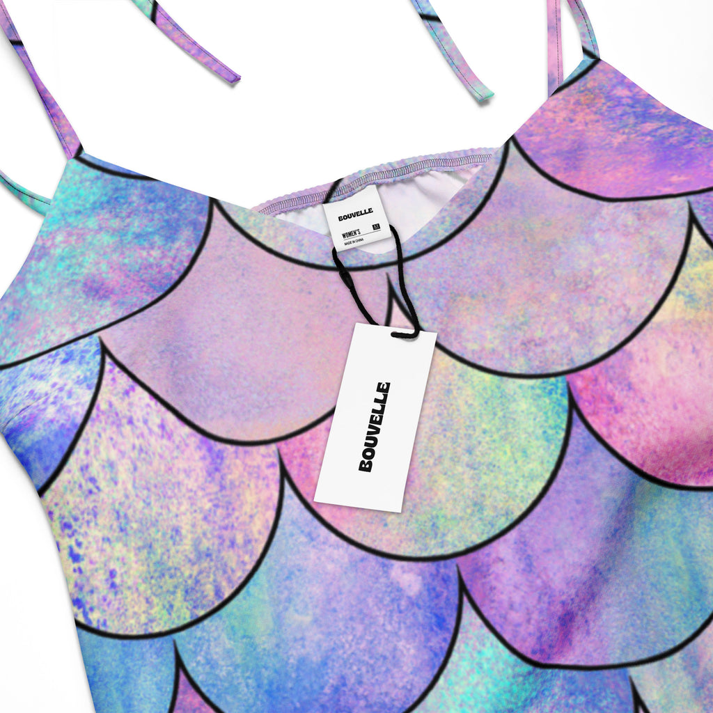 A vibrant pastel mermaid-scale print tank top with black outlined scales in purple blue and pink hues