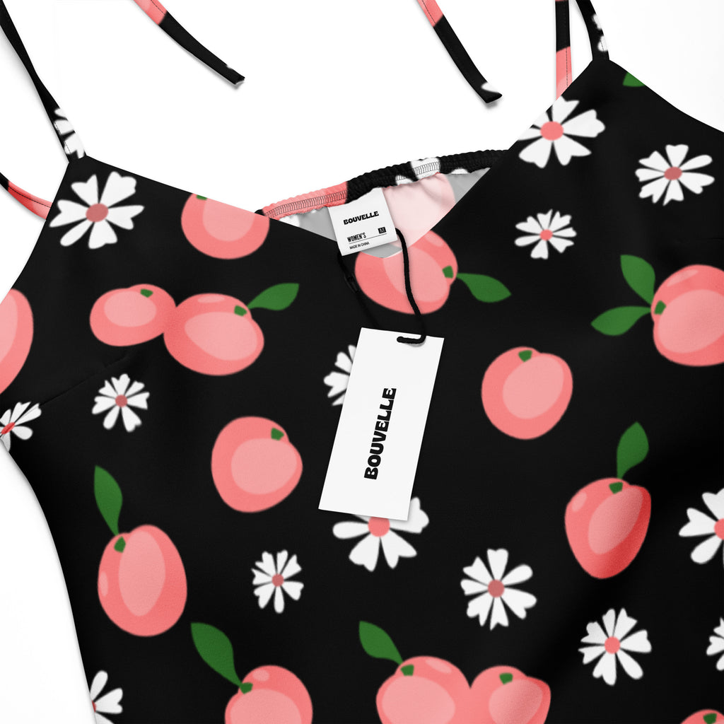 Black spaghetti strap midi slip dress by bouvelle with pink peach and white daisy print and adjustable tie straps