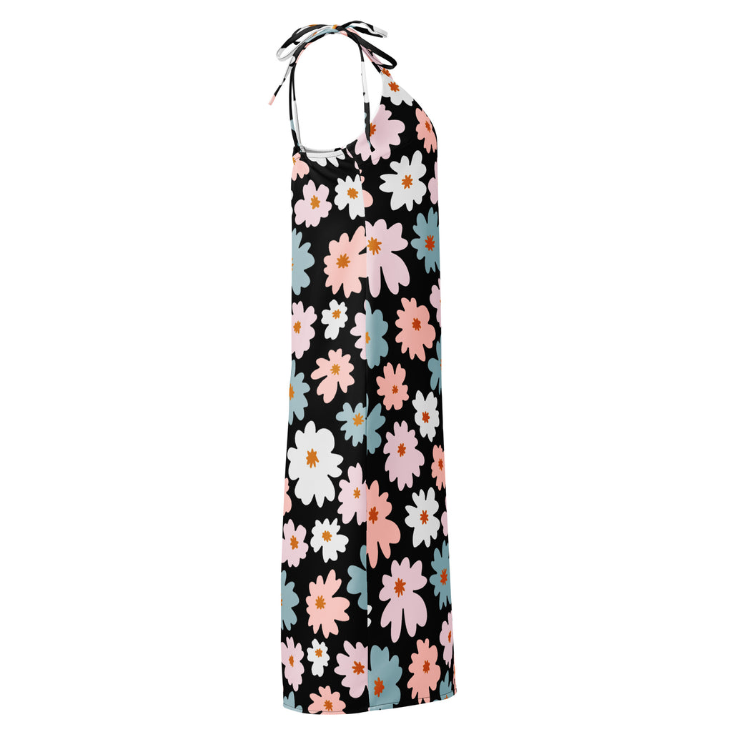 A black halter neck maxi dress with vibrant pink white and light blue floral pattern and adjustable tie straps