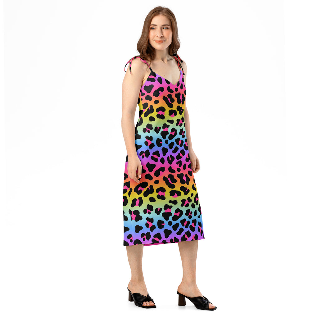 Woman wearing a colorful leopard print dress on a white background