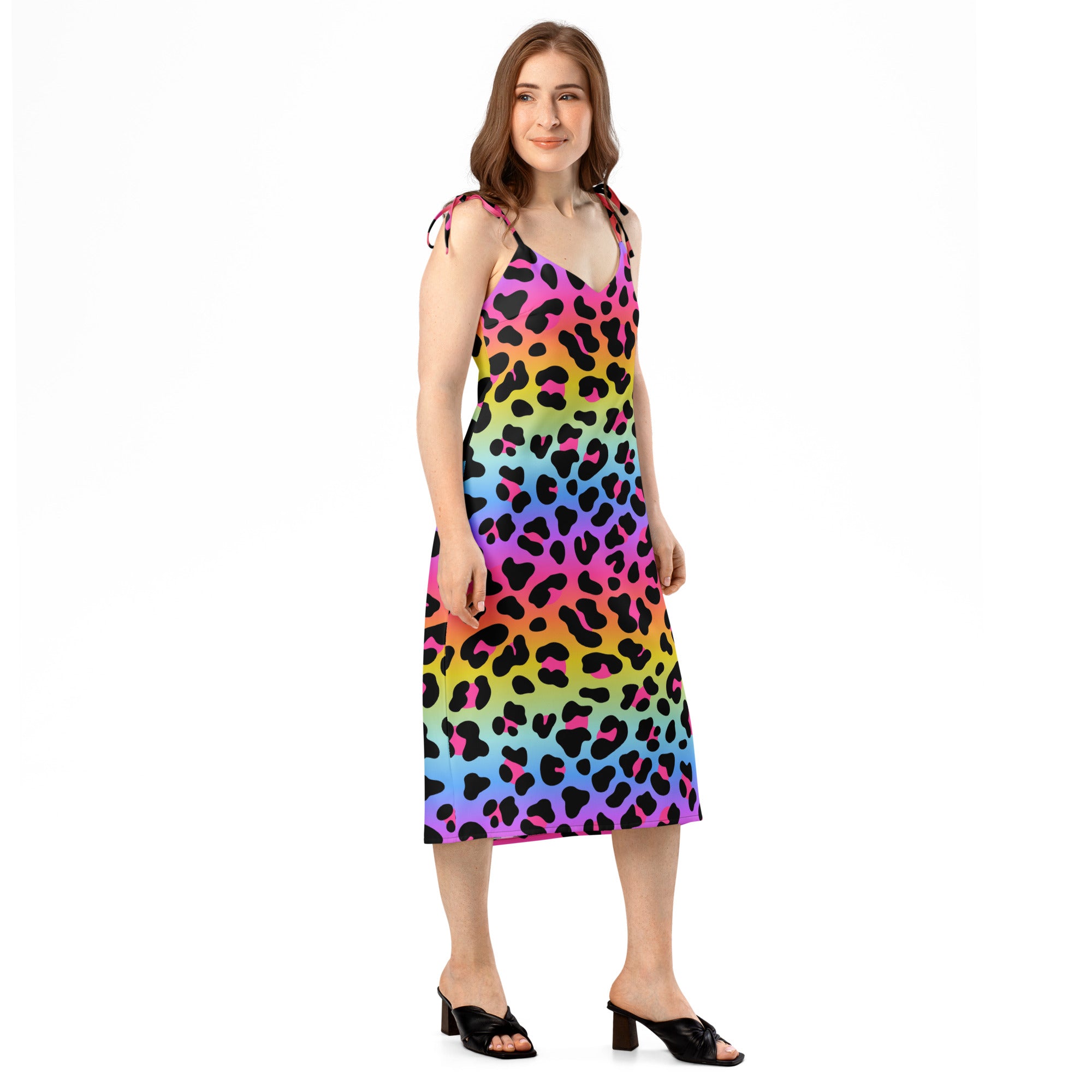Woman wearing a colorful leopard print dress on a white background