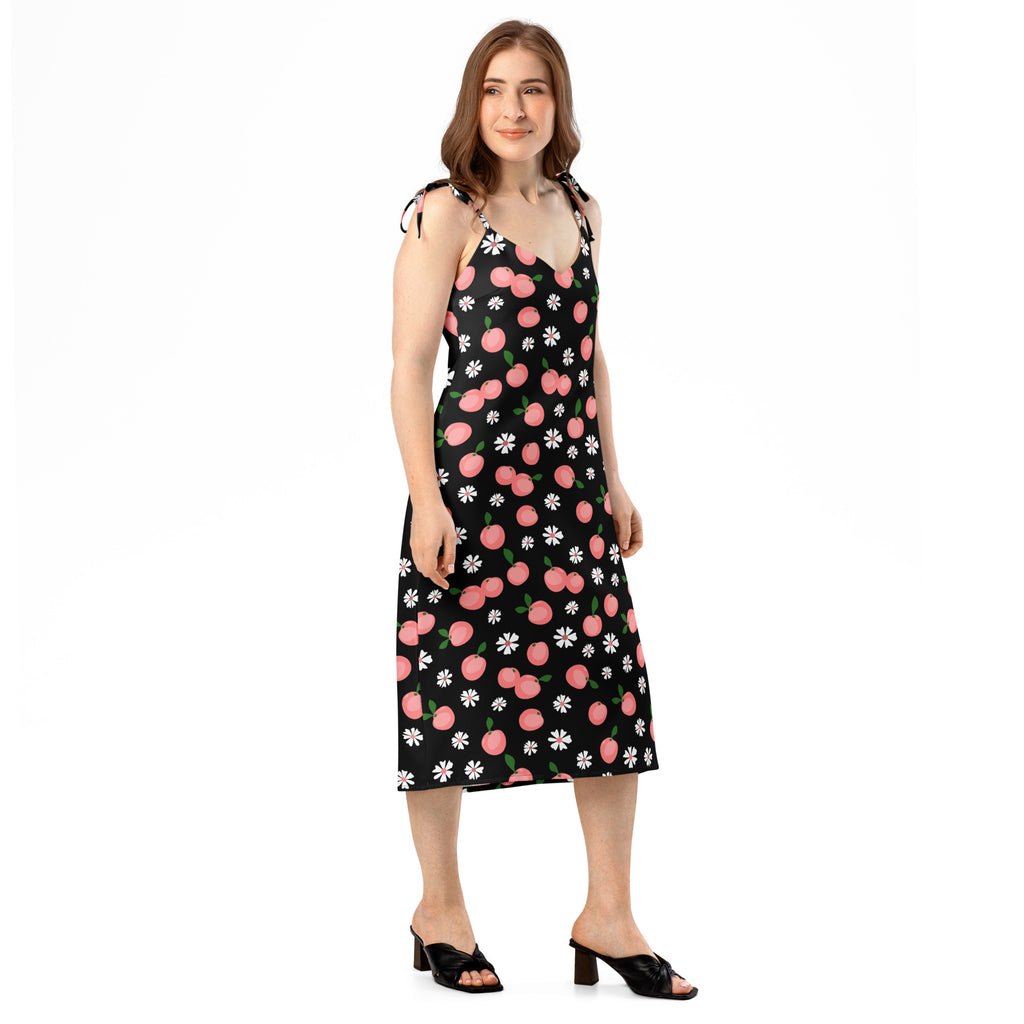 Black midi slip dress with pink cherry and white daisy print featuring adjustable tie spaghetti straps and built-in bra