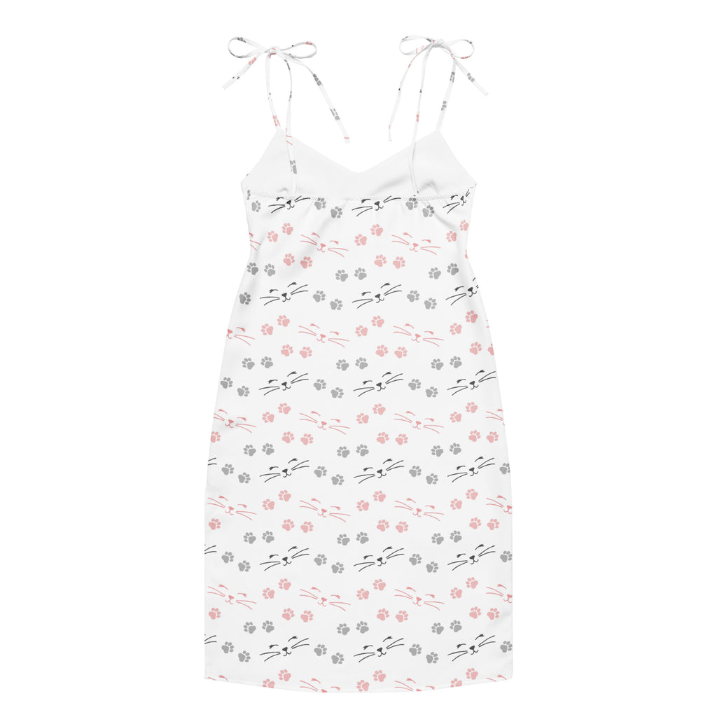 White spaghetti strap midi slip dress with pink and gray cat face and paw print pattern and adjustable tie straps