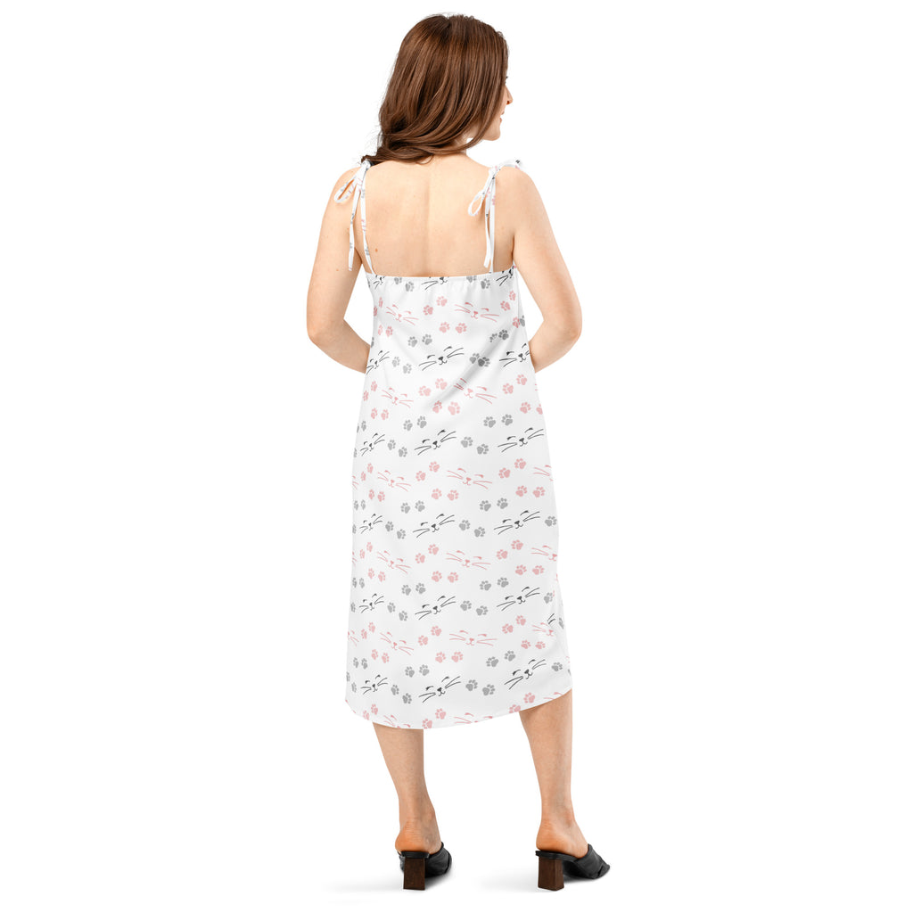 White midi slip dress with adjustable tie straps, built-in bra, and playful pink, gray, and black cat face pattern