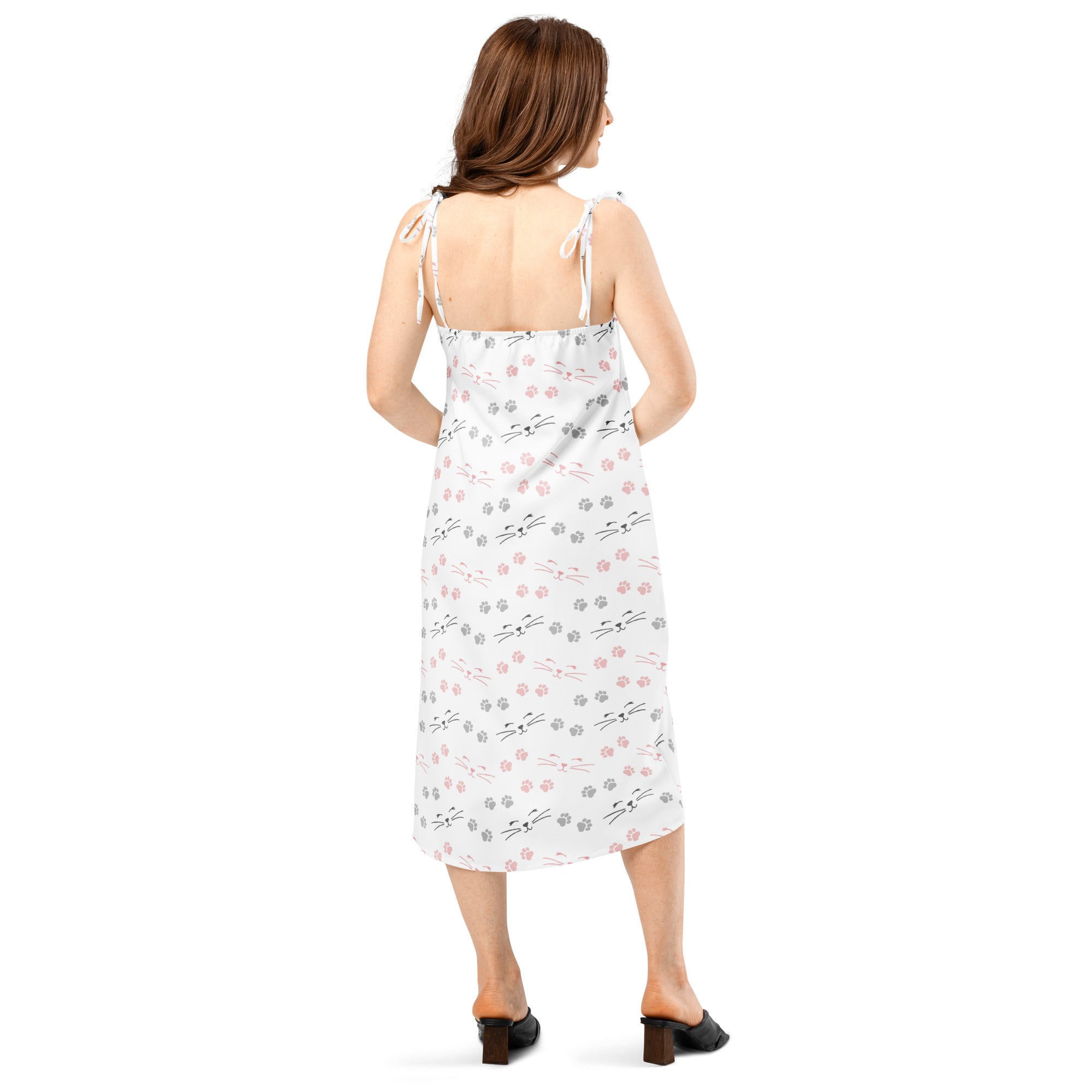 White midi slip dress with adjustable tie straps, built-in bra, and playful pink, gray, and black cat face pattern