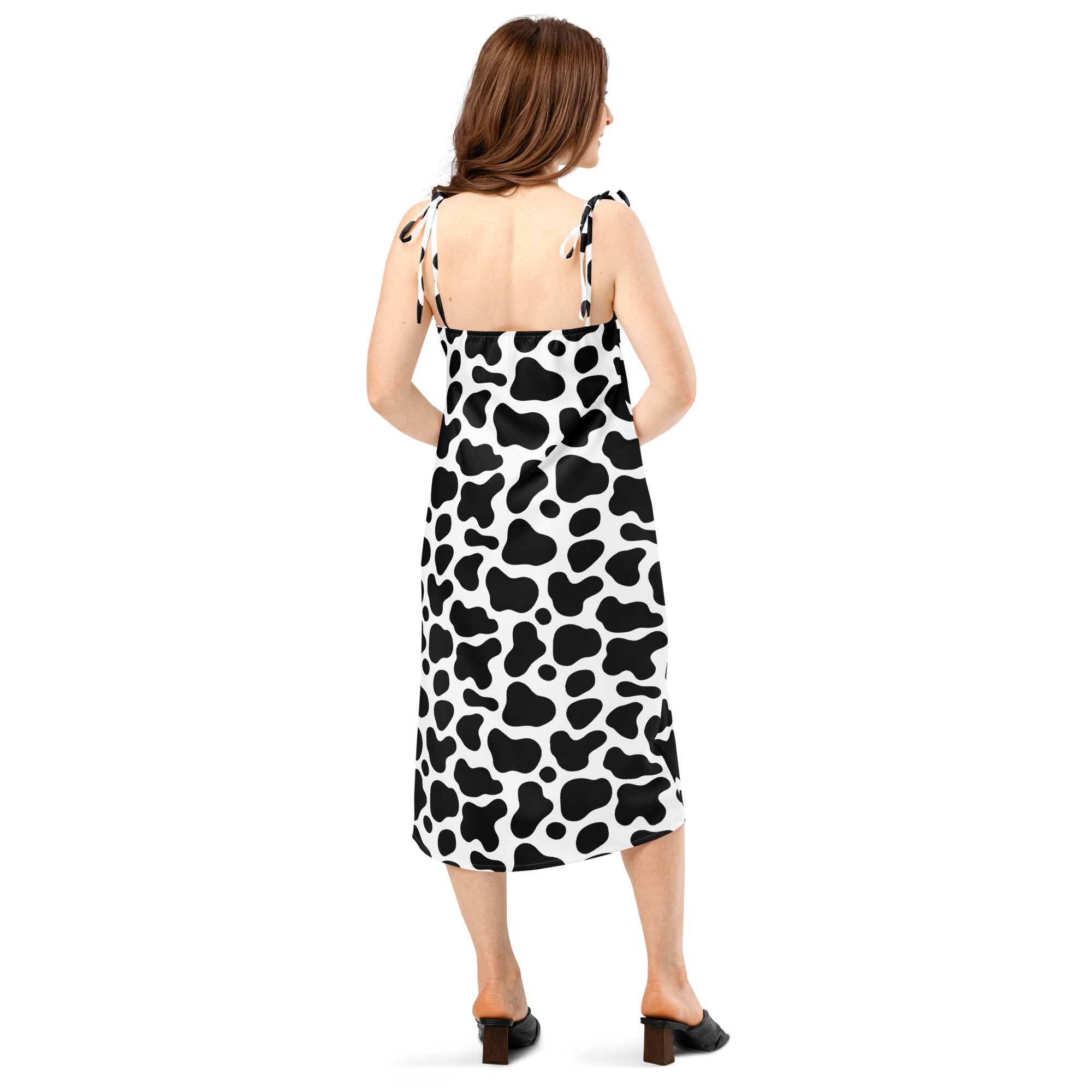Women’s midi slip dress with black and white cow print featuring thin adjustable tie straps and built in bra