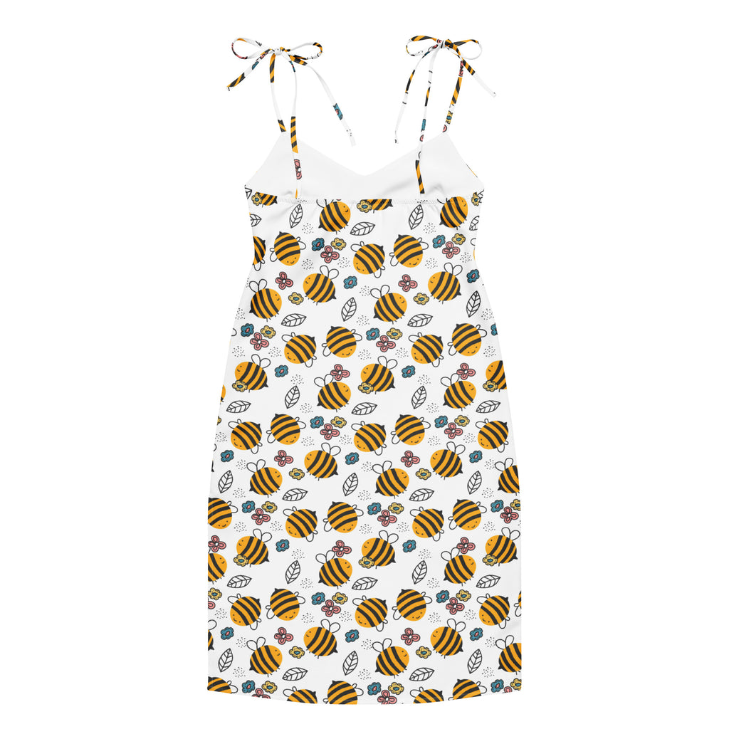 A white sleeveless women’s midi slip dress with adjustable tie straps featuring yellow and black bumblebee and floral patterns