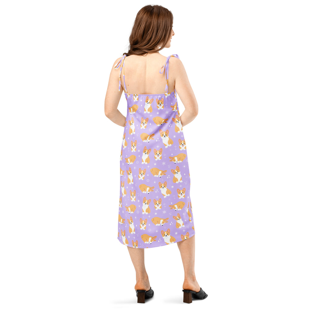 Woman wearing a purple slip dress with dog pattern on a white background