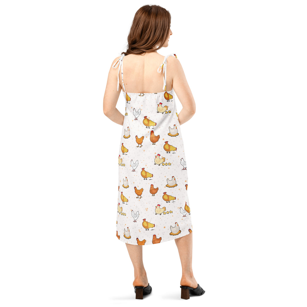 Woman wearing a white dress with chicken pattern on a white background
