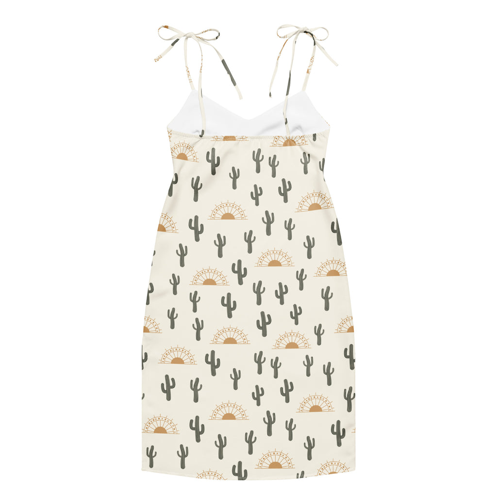 White midi sundress with adjustable tie straps and black cactus and tan sunburst print for desert style wear