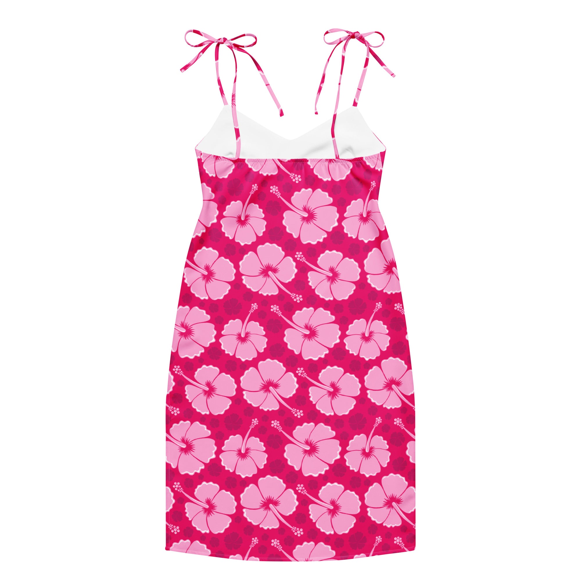 A vibrant pink hibiscus patterned women’s tropical slip midi dress with adjustable tie straps and a white underlayer