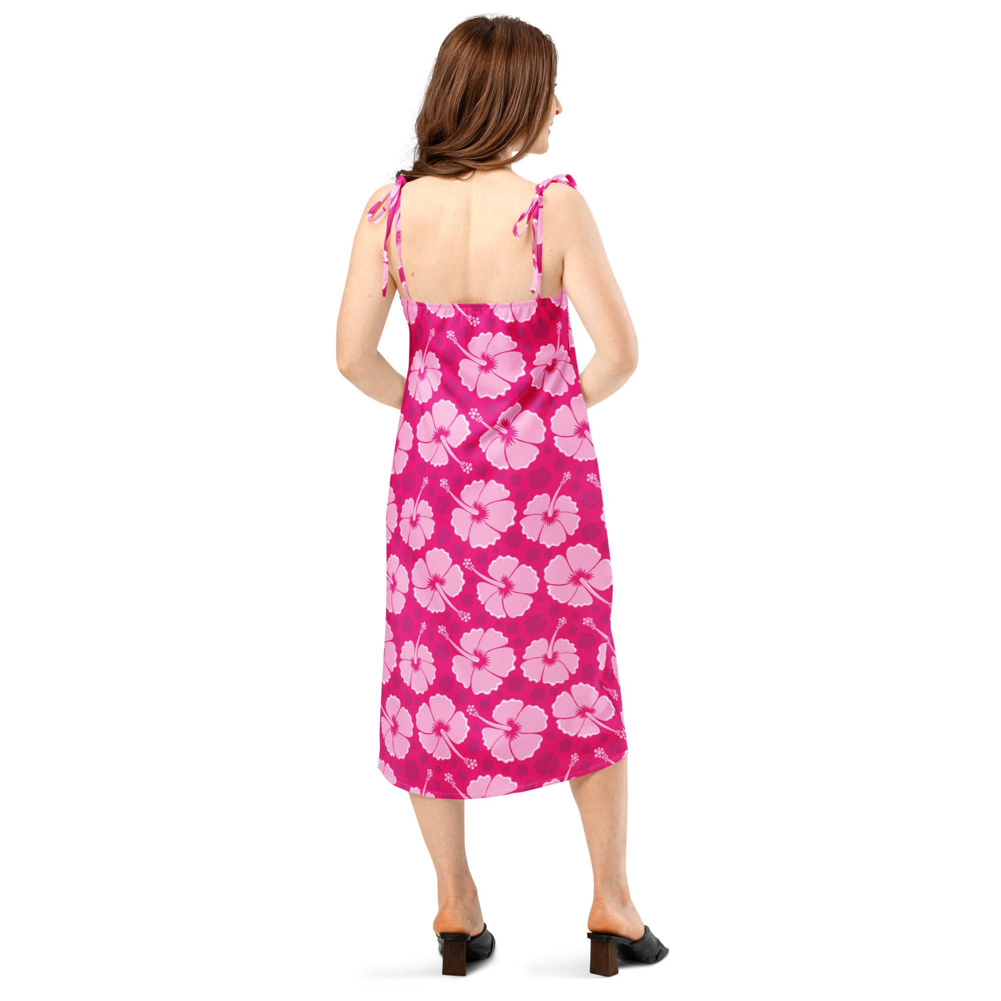 A vibrant pink midi slip dress with light pink hibiscus pattern and adjustable tie-back straps for women
