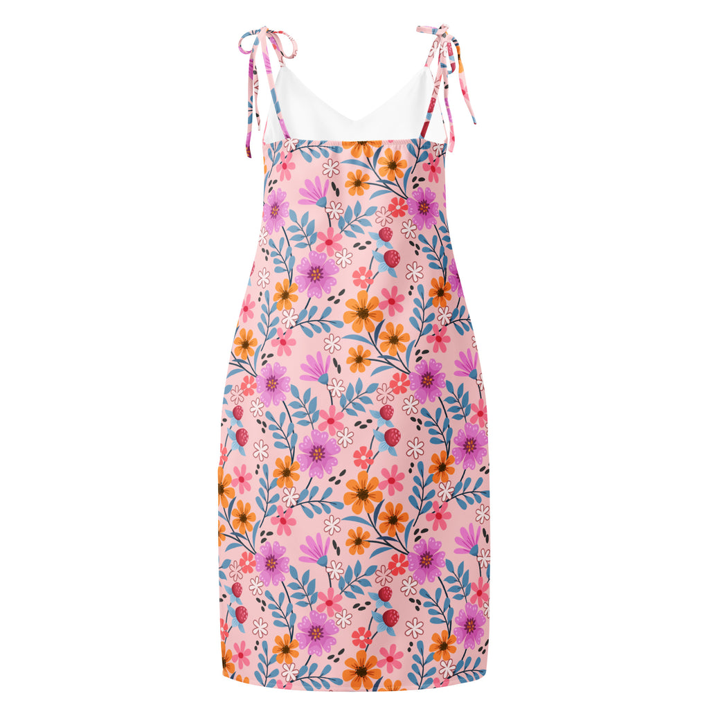 A pink floral print midi slip dress with adjustable tie straps and a fitted silhouette for women