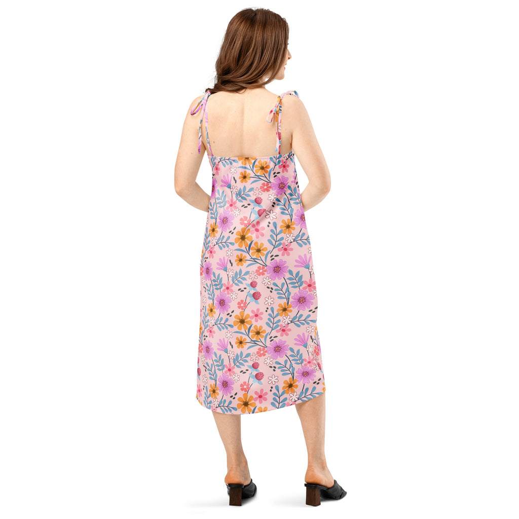 Women’s pink floral slip midi dress with adjustable tie-back straps and backless design showing back side