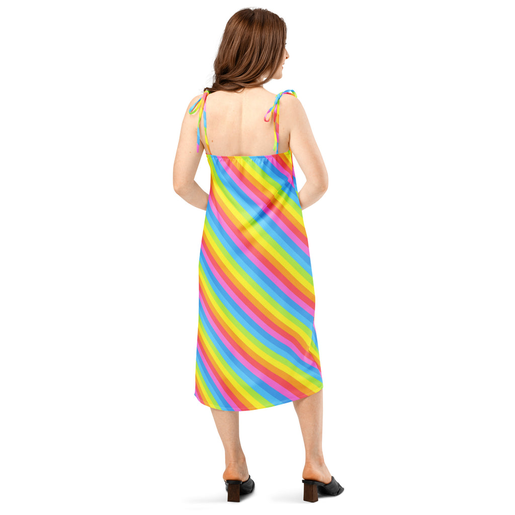 A vibrant rainbow stripe slip midi dress with adjustable tie straps and flowing satin-like fabric for women