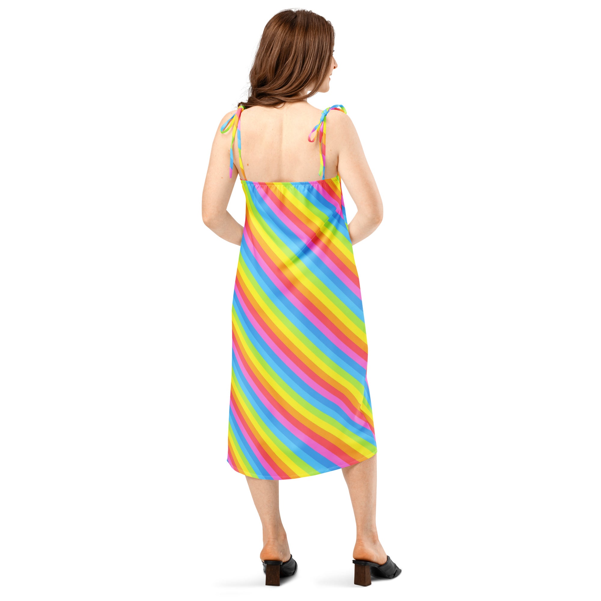 A vibrant rainbow stripe slip midi dress with adjustable tie straps and flowing satin-like fabric for women