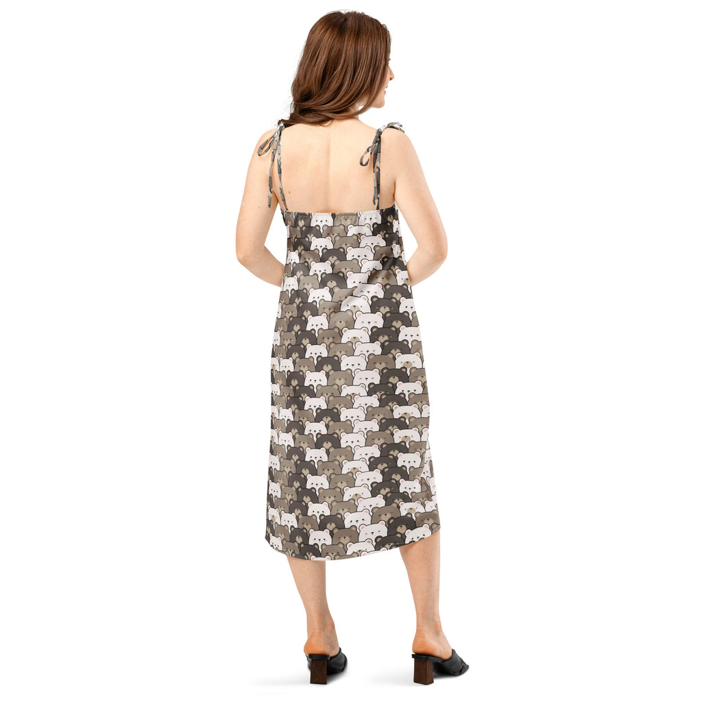 A woman wears a women’s bear face slip midi dress with adjustable tie straps and an all-over fox pattern