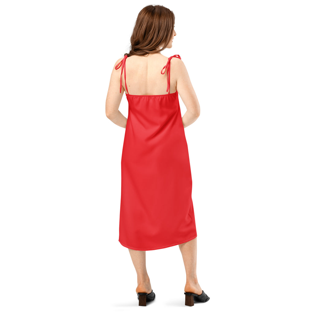 Woman wearing a red dress with thin straps on a white background