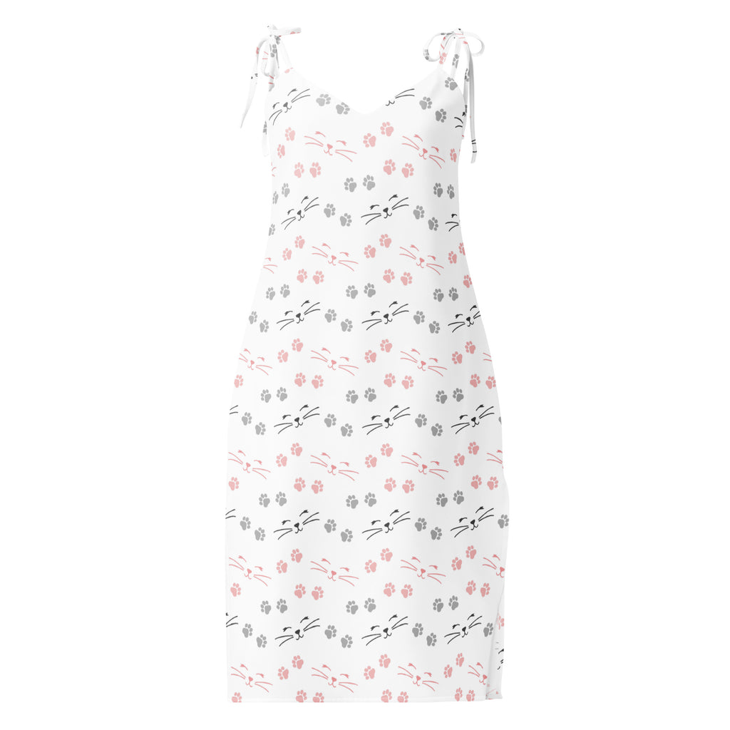 White sleeveless midi slip dress with pink and gray cat face and paw print pattern featuring adjustable tie straps