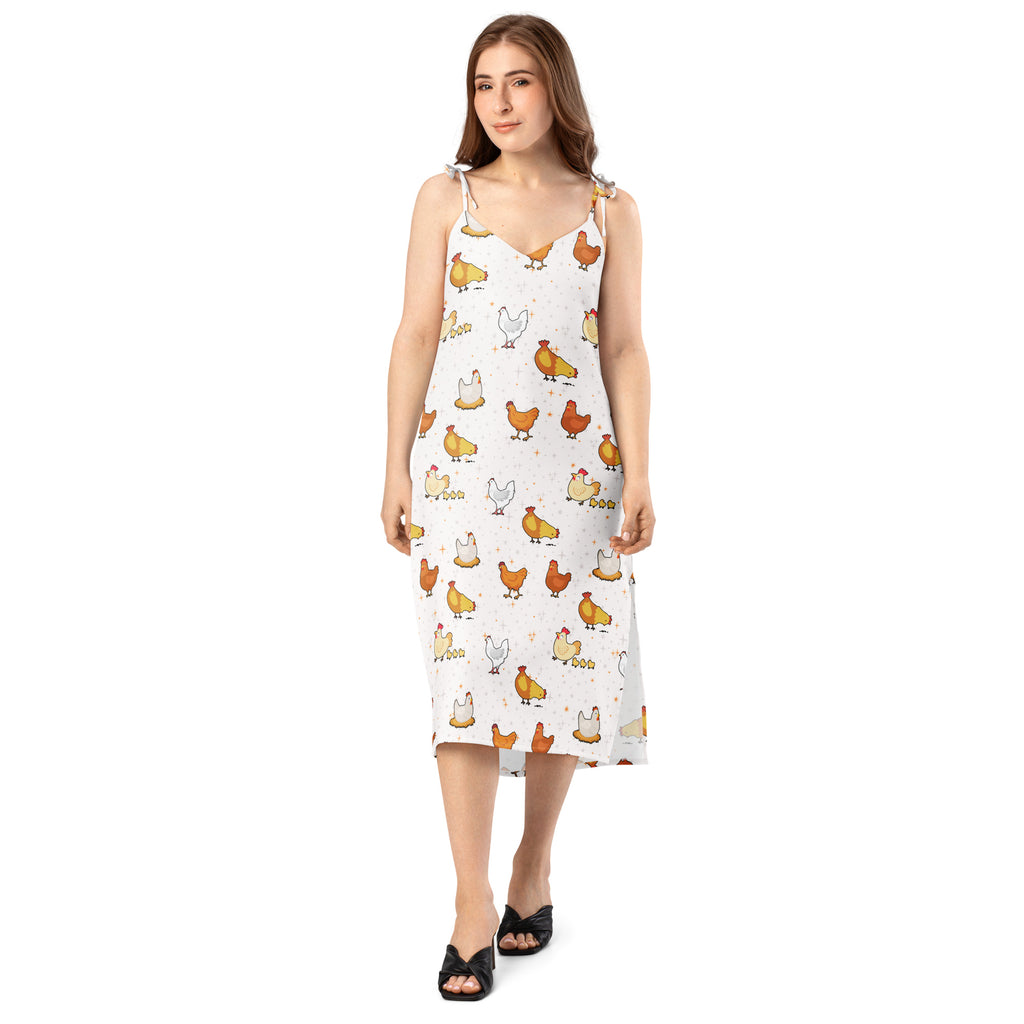 Woman wearing a white dress with chicken pattern on a white background