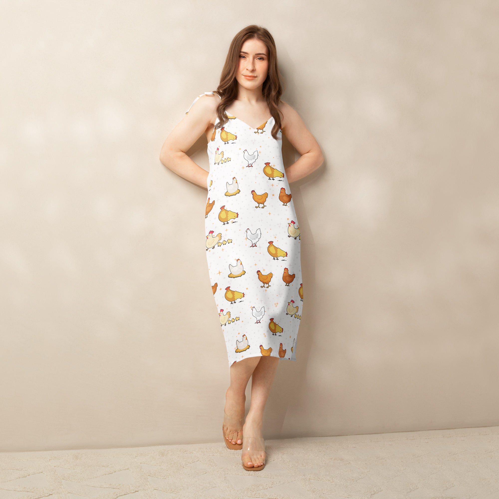 Woman wearing a chicken dress against a plain background