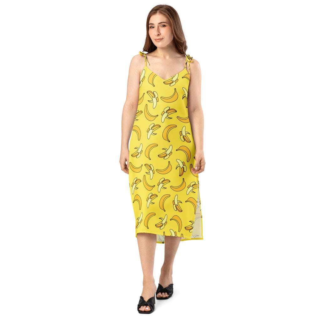 Woman wearing a yellow dress with banana pattern on a white background