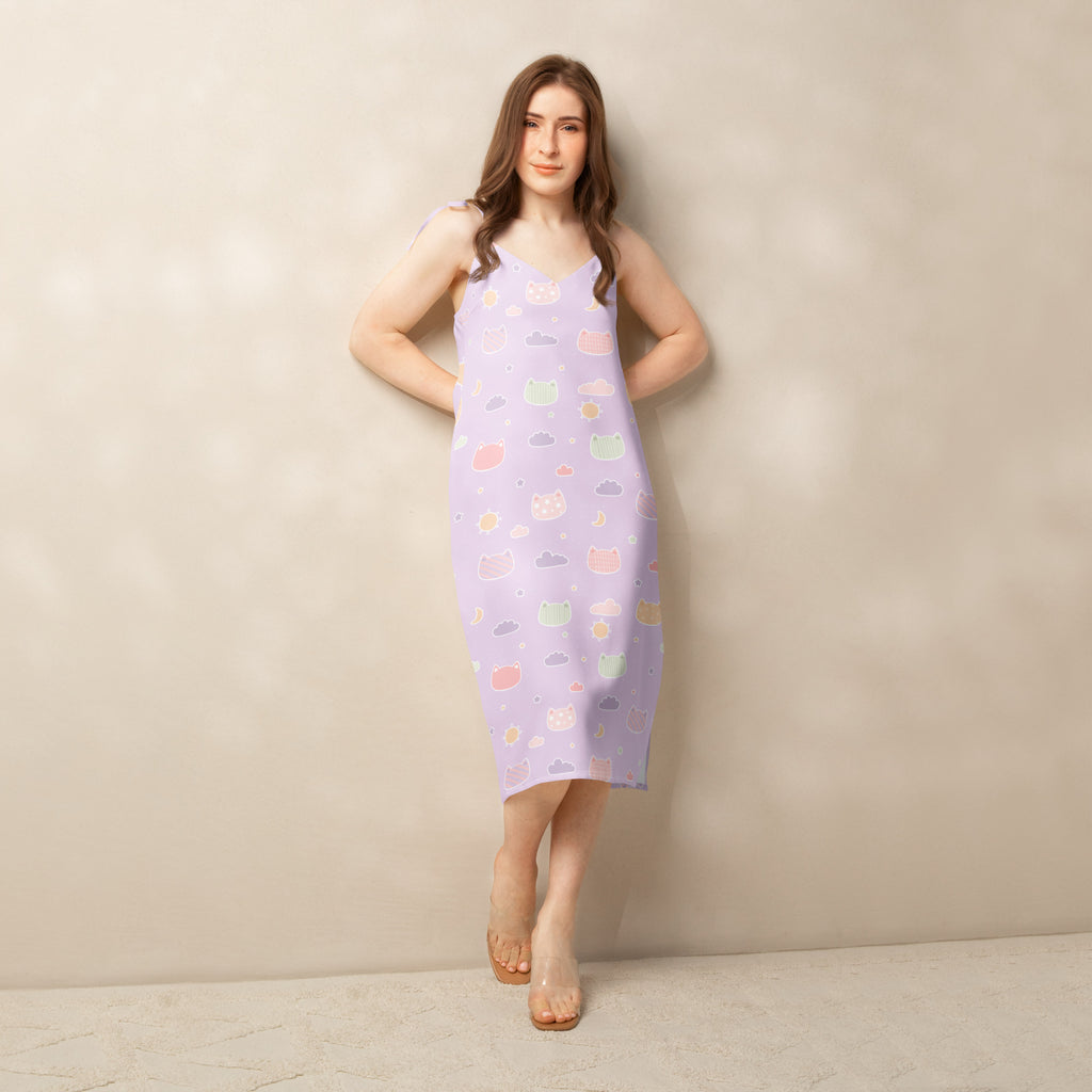 A lavender sleeveless midi dress with pastel kawaii cats and clouds pattern featuring adjustable tie straps and built-in bra
