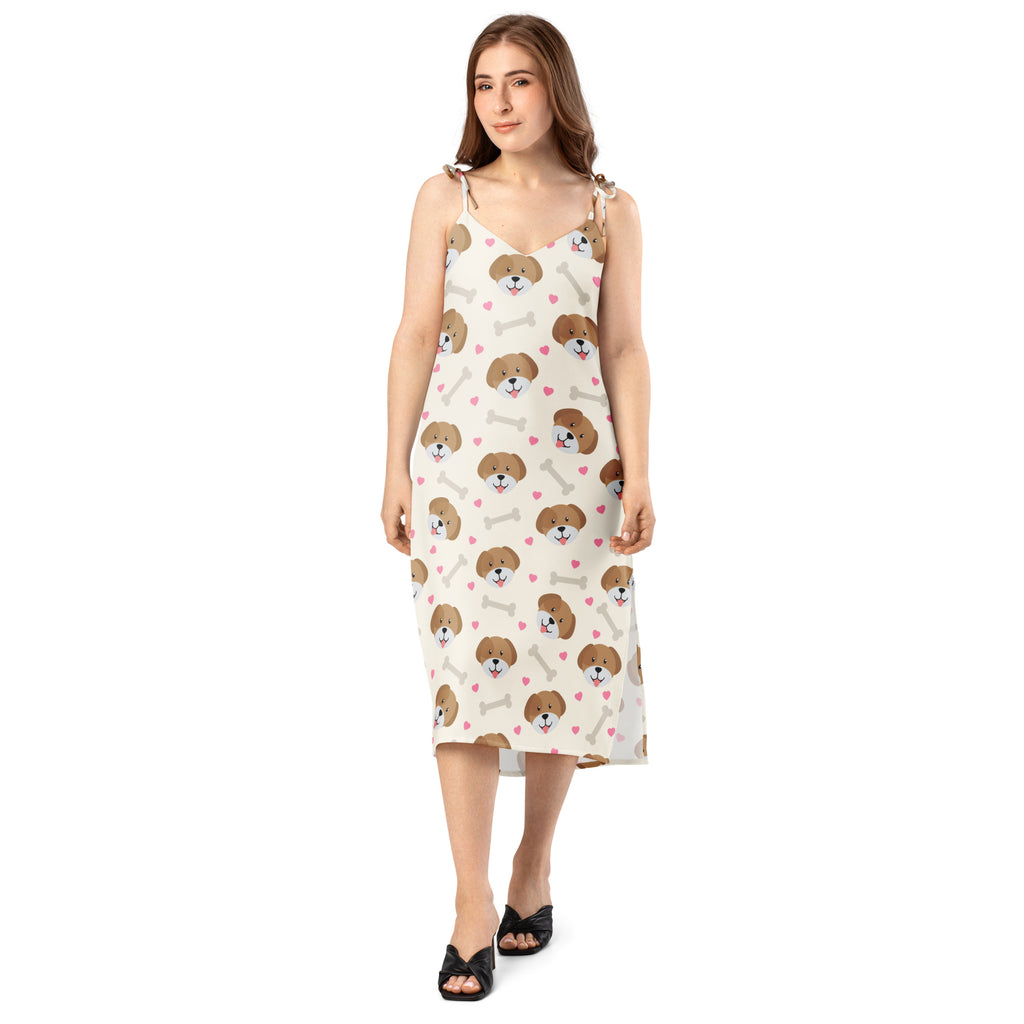 White sleeveless midi slip dress with playful brown dog bone and pink heart print and adjustable tie straps