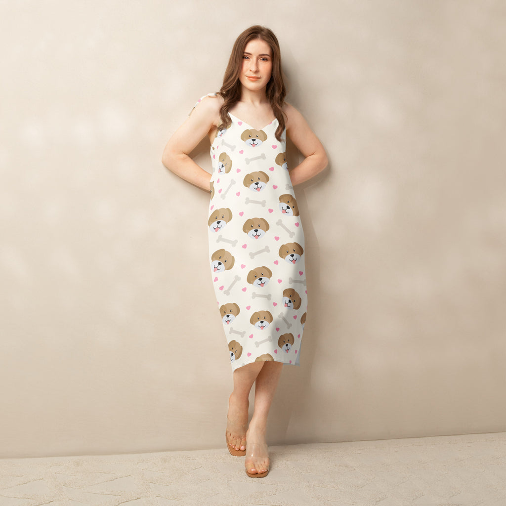 White sleeveless midi slip dress with brown puppy face, bones, and pink heart print, adjustable tie straps, and built in bra