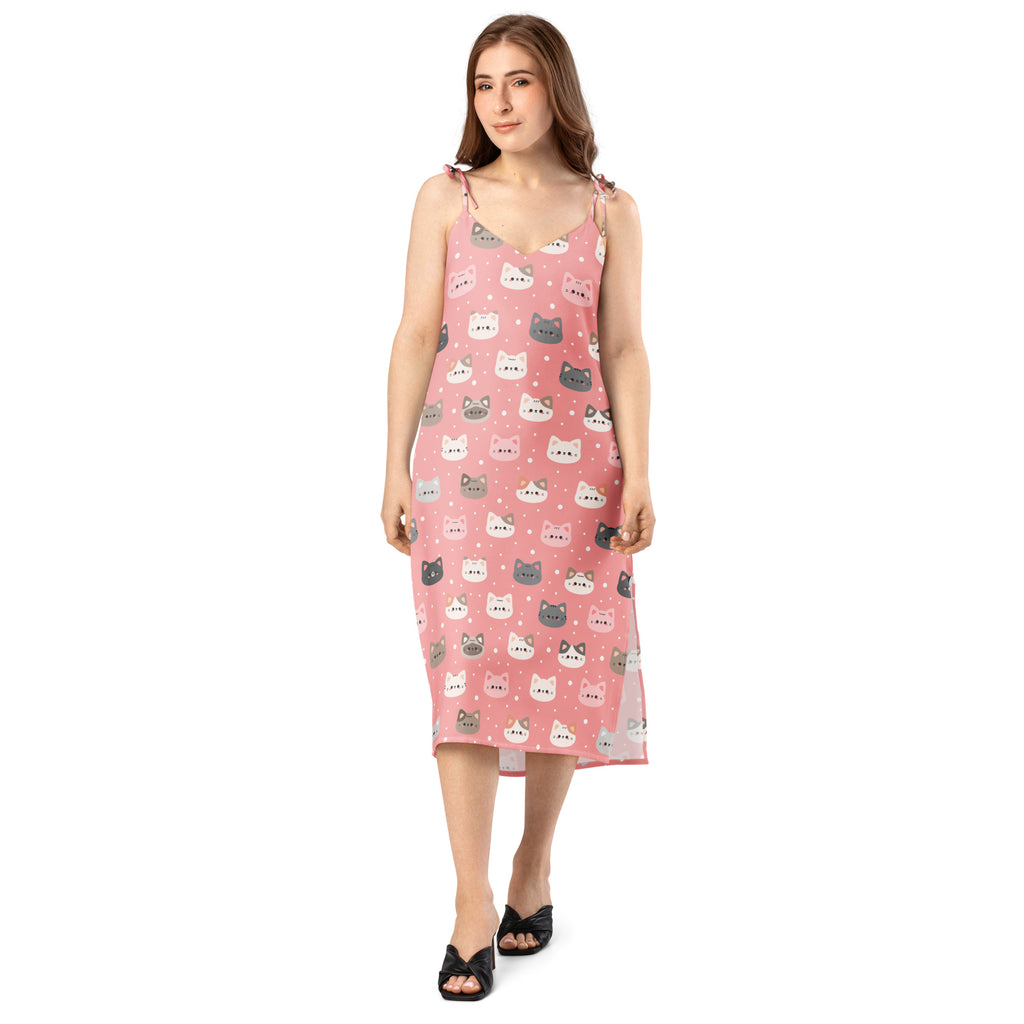 Women’s pink sleeveless midi slip dress with adjustable tie straps and built in bra featuring colorful cartoon cats