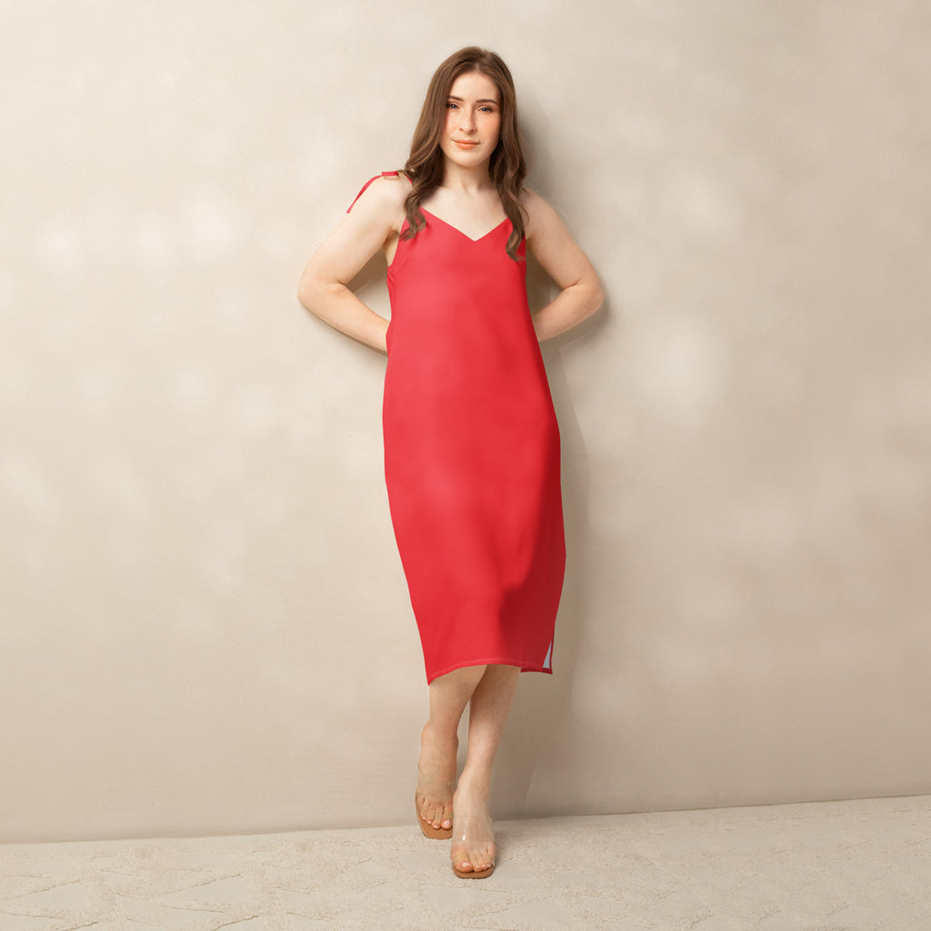 Woman wearing a red slip dress against a beige background