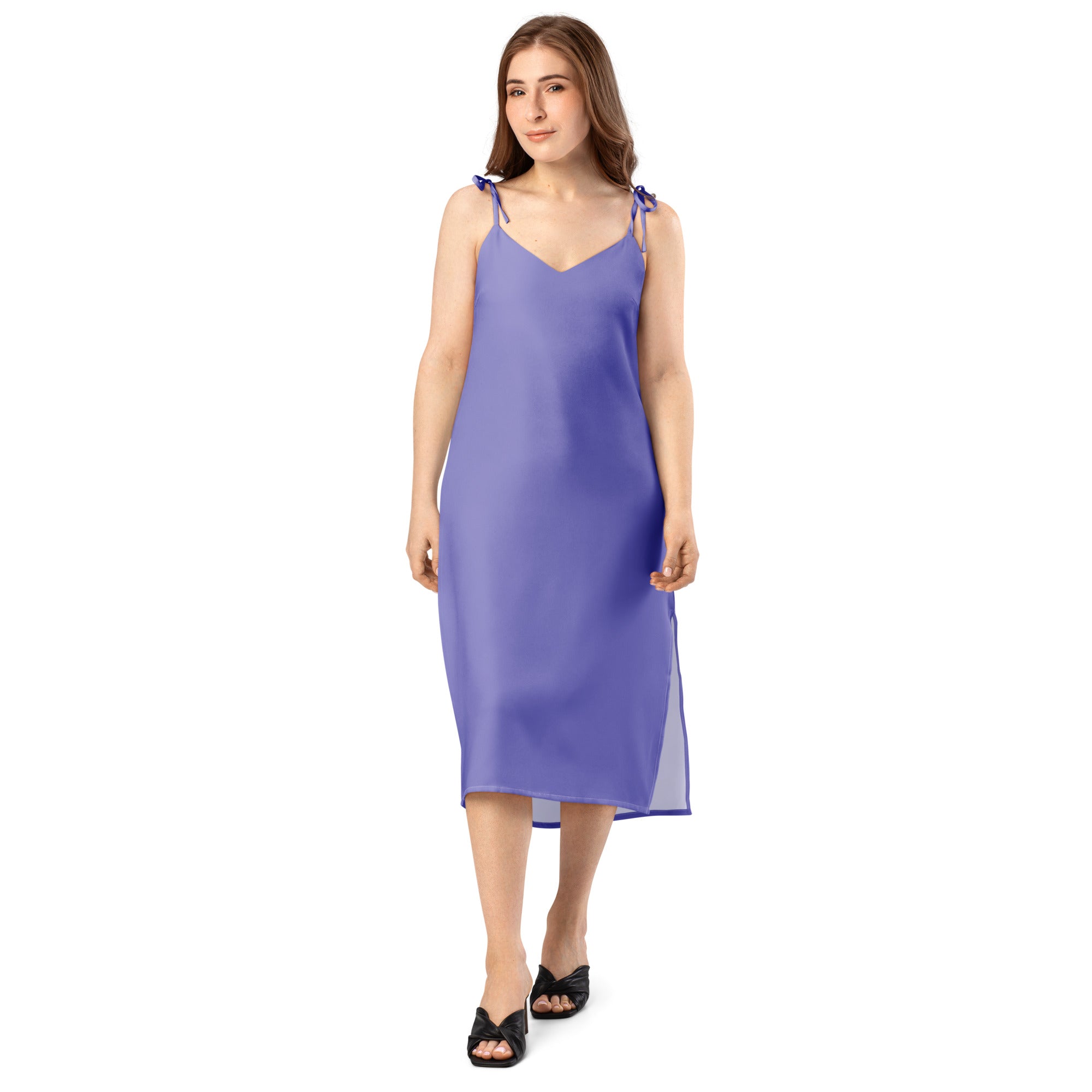 Woman wearing a purple slip dress on a white background