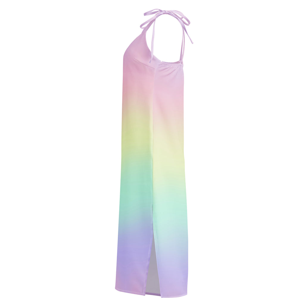 A flowing halter neck maxi dress with a pastel rainbow gradient pink lavender and green and adjustable tie straps