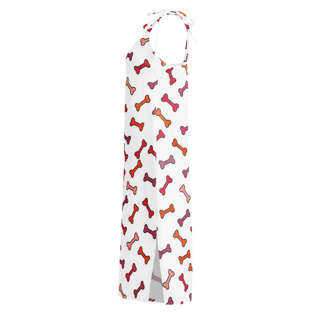 White halter-neck midi dress with colorful red orange and pink dog bone pattern and adjustable tie straps with built in bra