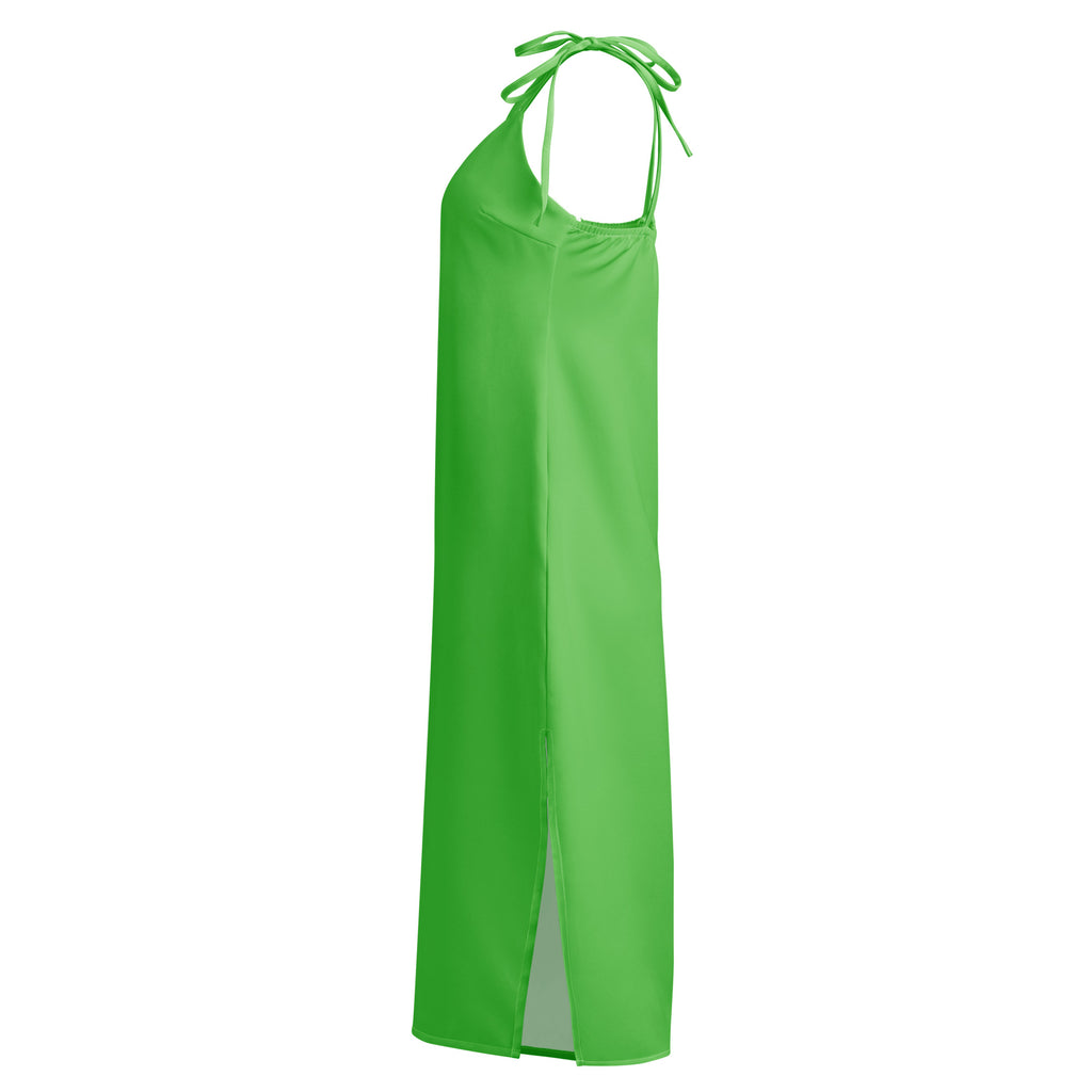 Women's green slip dress with adjustable tie straps and built-in bra, midi length.