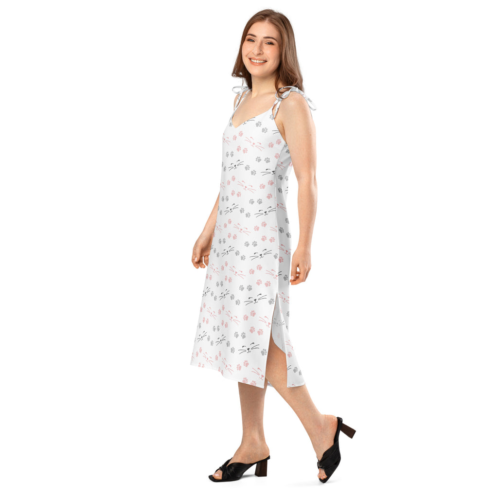 White sleeveless midi slip dress with adjustable tie straps and playful pink gray black cat paw print pattern