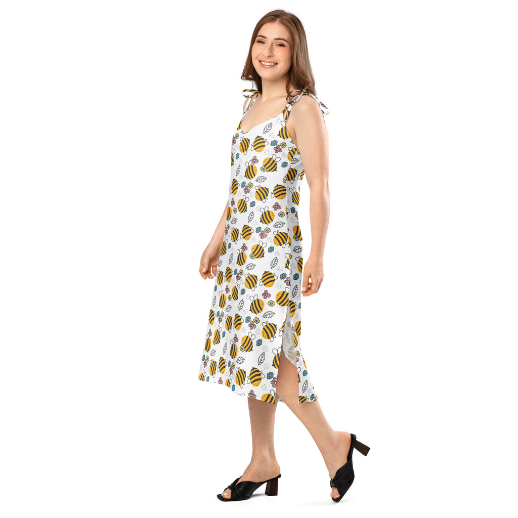 White sleeveless midi slip dress with yellow and black bumblebee pattern green leaves purple flowers and adjustable straps