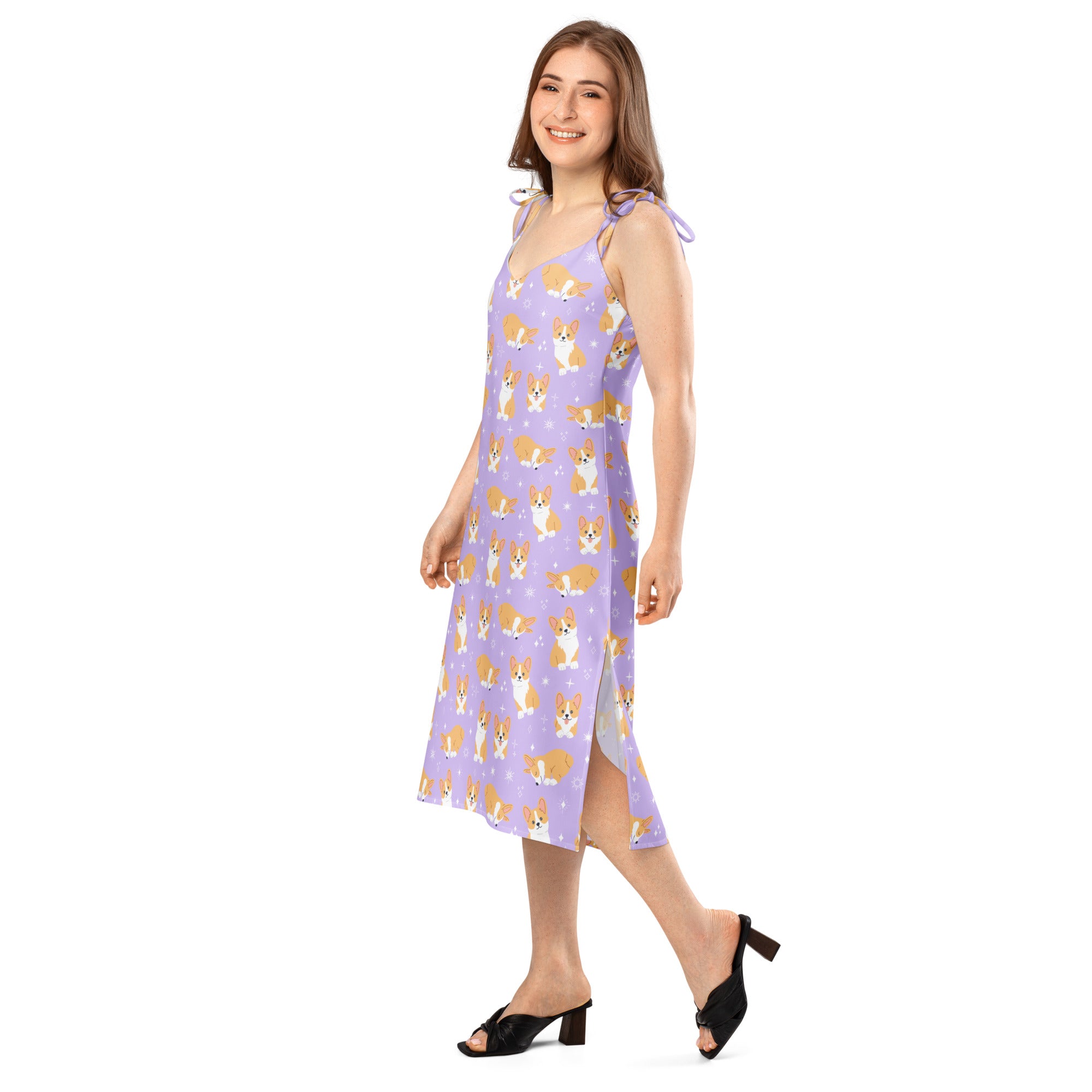 Woman wearing a purple dress with dog pattern on a white background