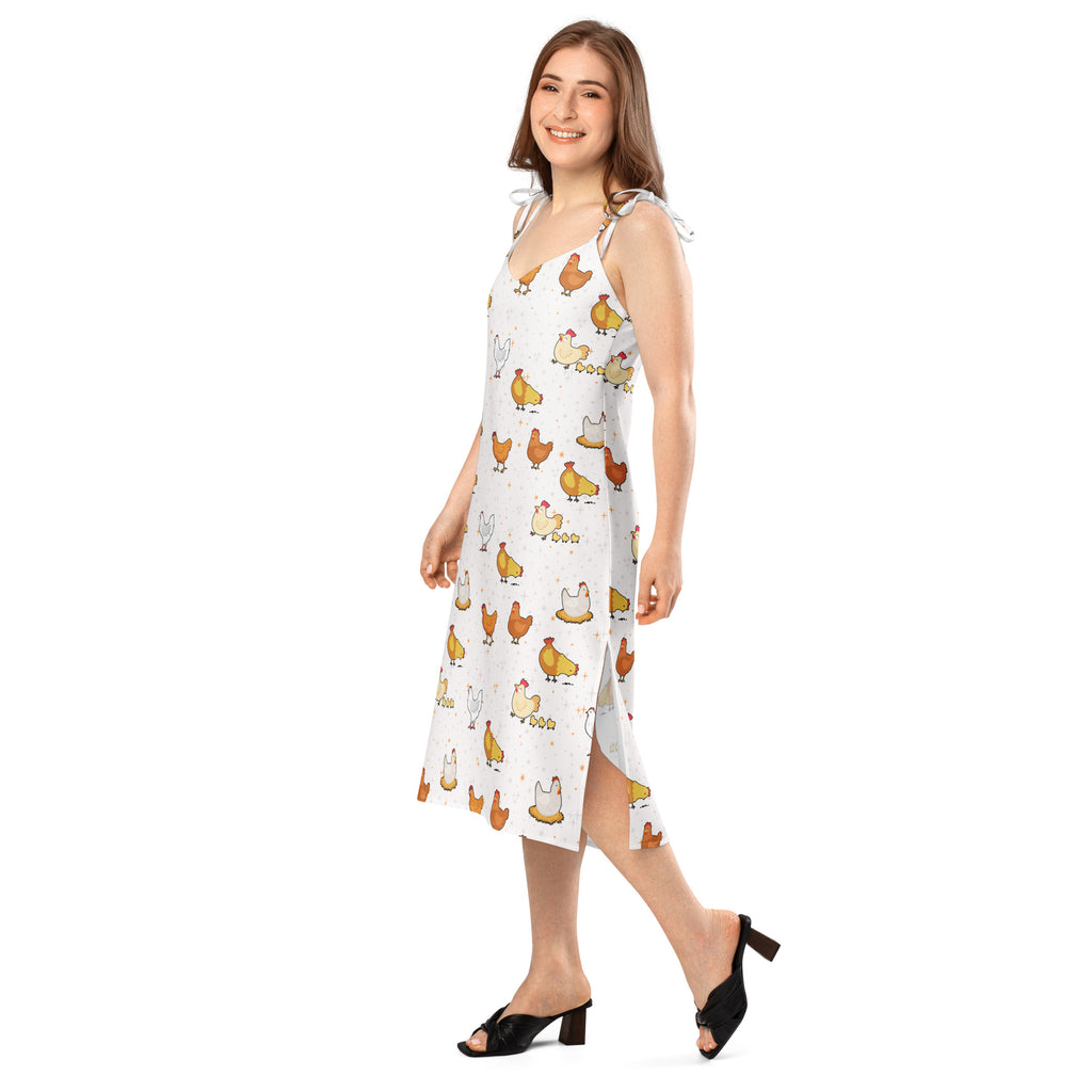 Woman wearing a white dress with chicken pattern on a white background