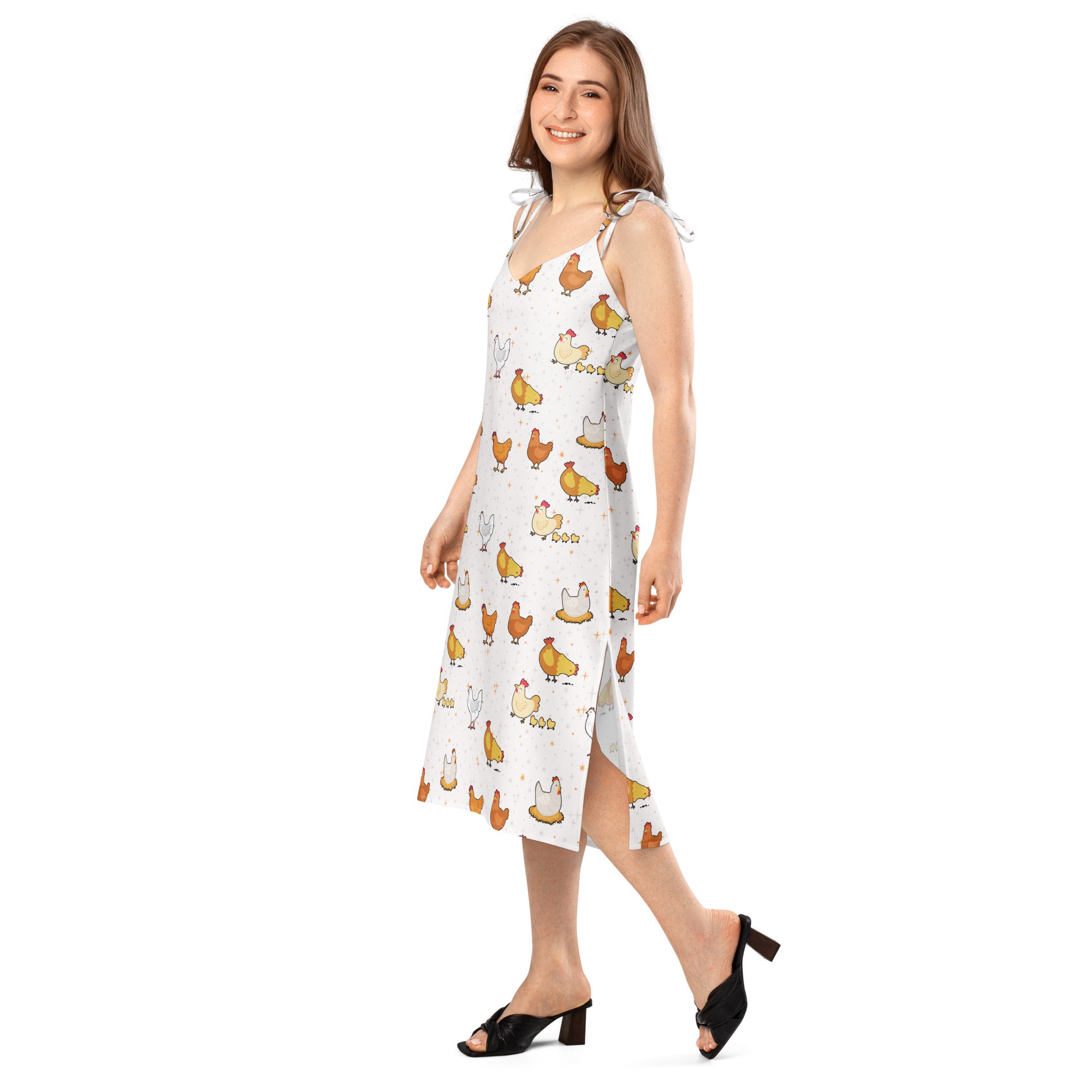 Woman wearing a white dress with chicken pattern on a white background